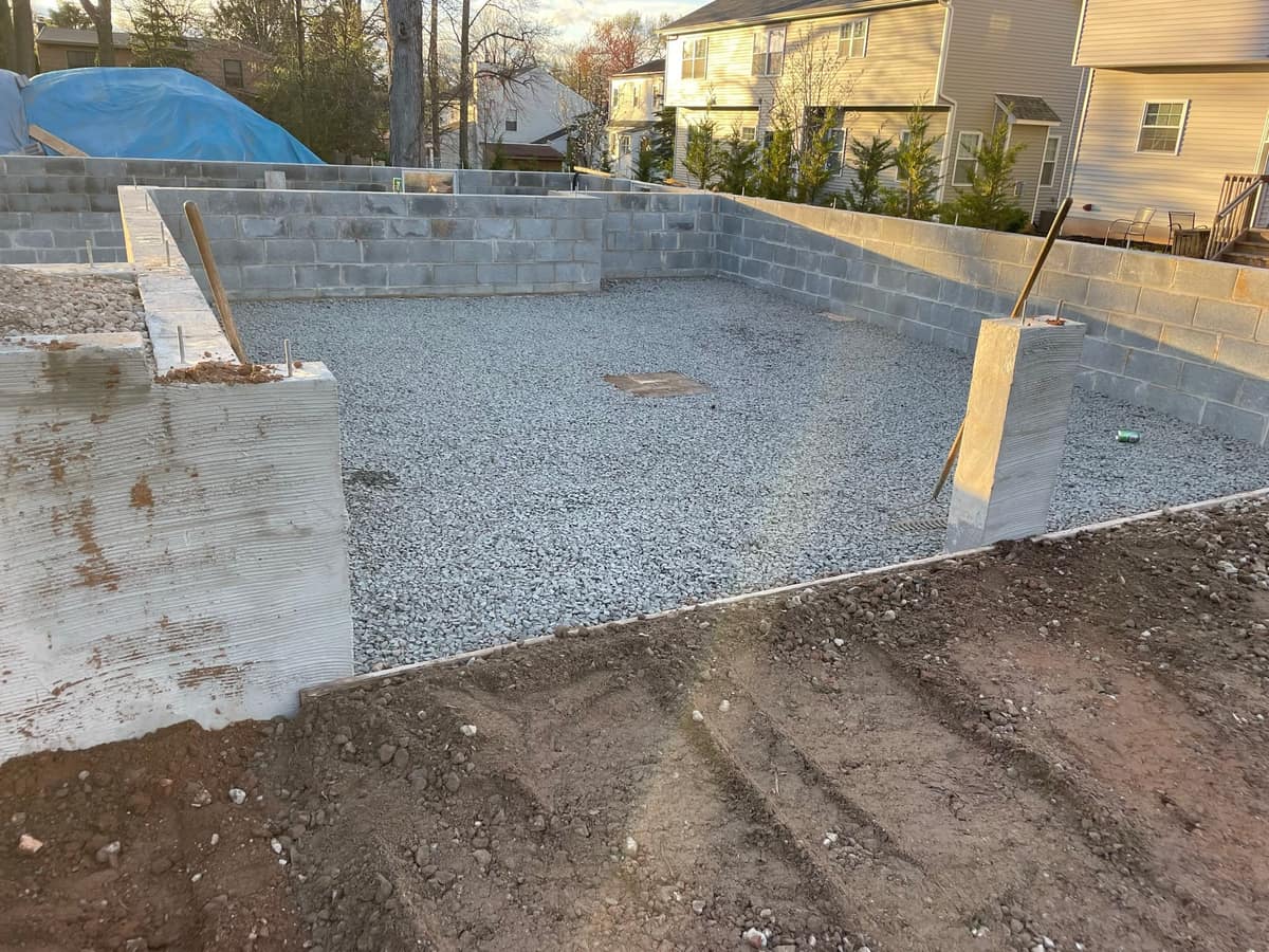 Foundation area with gravel base prepared for concrete and residential construction by Cursi Construction Inc.
