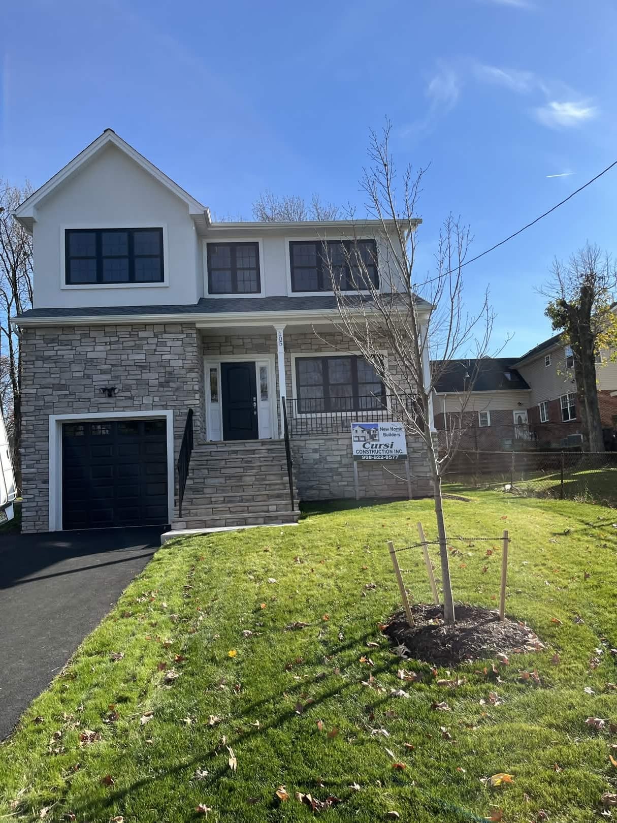 New home construction. Two-story colonial with stone facade, built by Cursi Construction Inc.