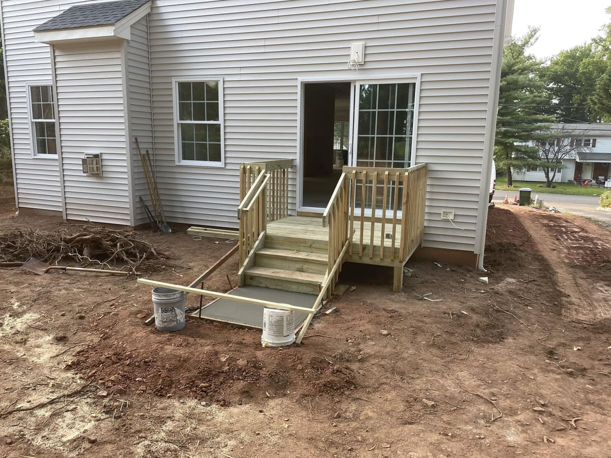 Rear entry stairs and small landing under construction on a residential home by Cursi Construction Inc.