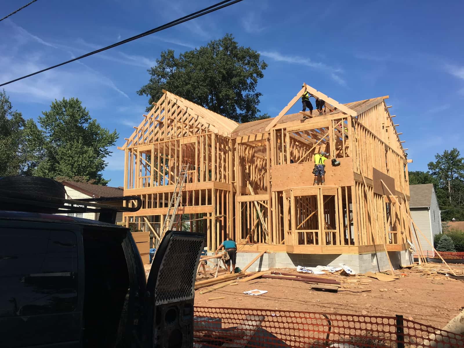 Wood framing and roof trusses being installed for a new multi-story residential build, by Cursi Construction Inc.